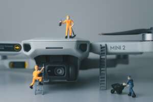 a couple of figurines standing on top of a camera